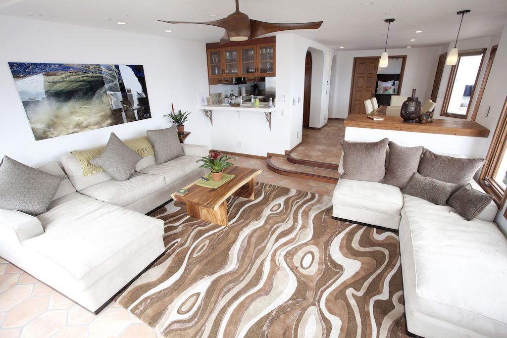 Living room with white sectional, open to the kitchen