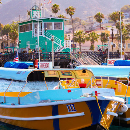 Colorful water taxi boats sit moored near the famous Green Pier at Avalon, on Catalina Island