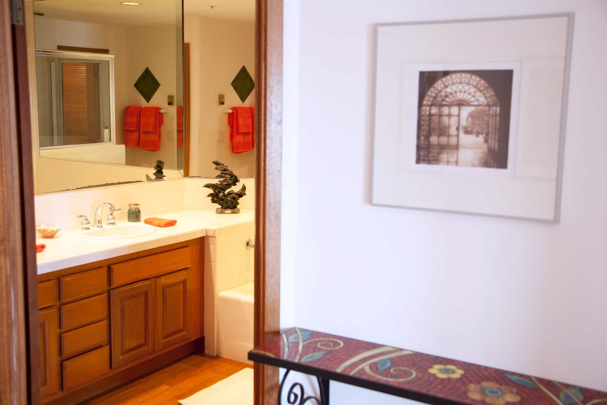 Bathroom with shower, vanity and framed art
