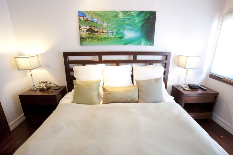 Bedroom with king bed and ocean painting