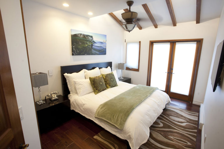 Bedroom with king bed, ceiling fan and French doors