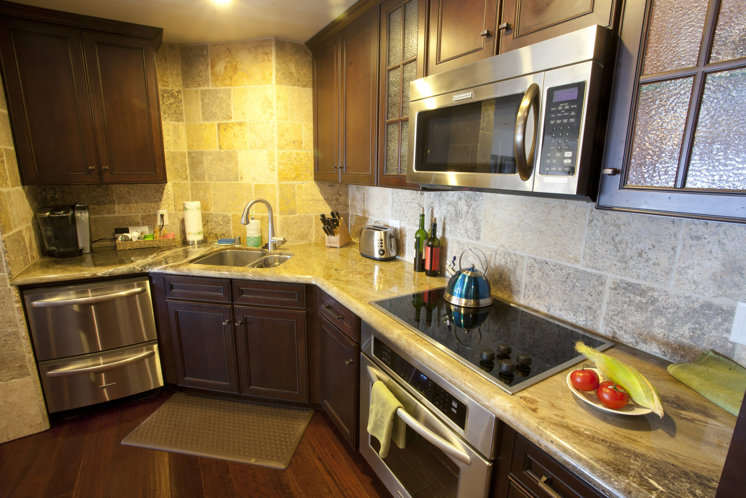 Kitchen with dark wood cabinets and stainless appliances
