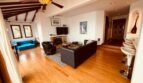 Living room with fireplace, leather sofas and wood floors